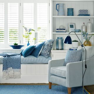 Small blue living room with built in window seat
