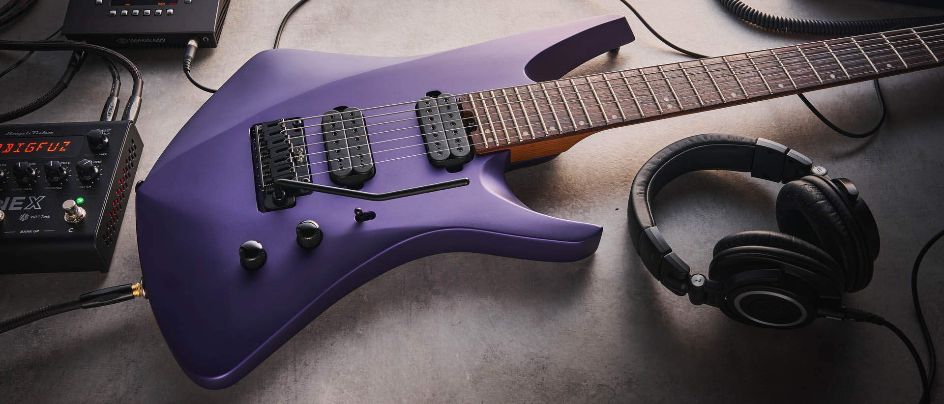 Sterling By Music Man Kaizen 7-string in Firemist Purple Satin, shot in close-up.