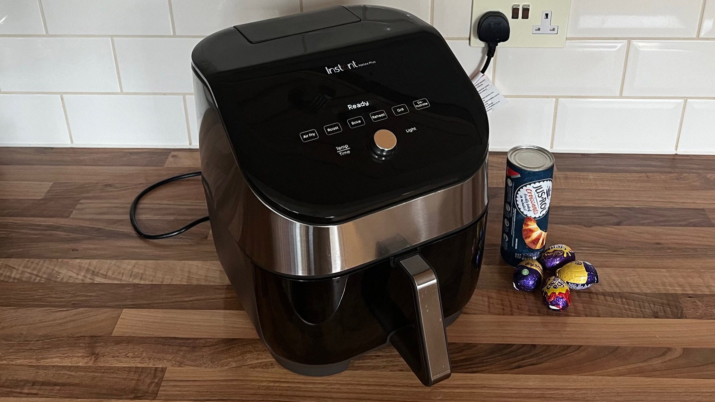 The Instant Vortex Plus 6-in-1 air fryer next to some Creme Eggs and pre-made croissant dough