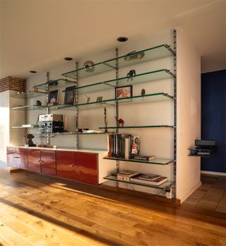 apartment interior with wood floor and glass and metal shelving