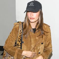 Hailey bieber wears a mercedes benz hat and suede jacket.