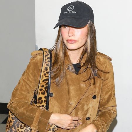 Hailey bieber wears a mercedes benz hat and suede jacket.