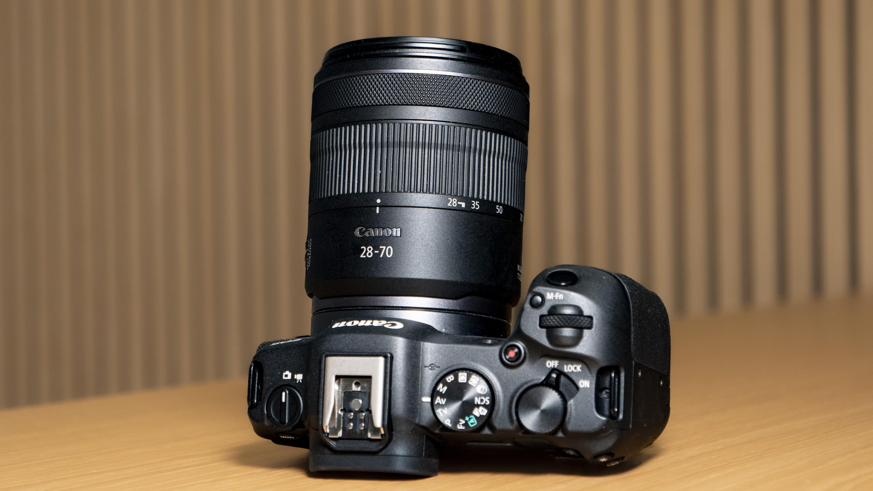 Canon RF 16-28mm F2.8 IS STM lens attached to a Canon EOS R8 on a wooden table