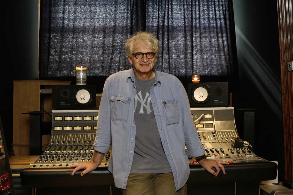Jack Douglas leaning against a recording desk