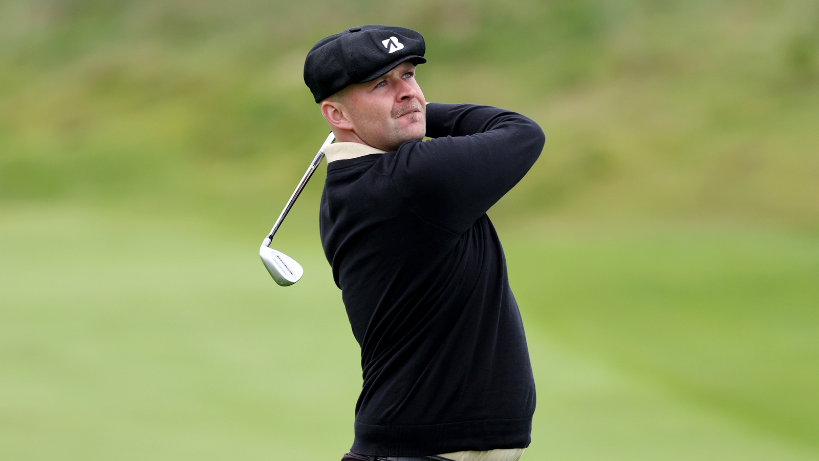 Harry Hall watches his wedge shot into the green
