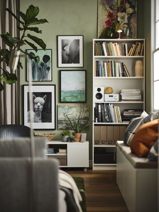 Living room with green walls, Ikea storage and wall art