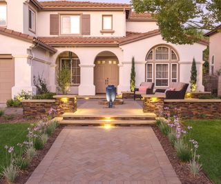 front yard with lighting and furniture on patio