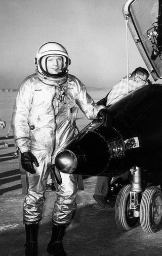 NASA test pilot Neil Armstrong is seen here next to the X-15 ship #1 after a research flight.