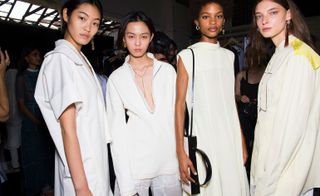 Models wear white shirts, tops and trousers