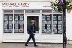 A man walks past housing market listings in an estate agent's window (image: Jason Alden/Bloomberg via Getty Images)