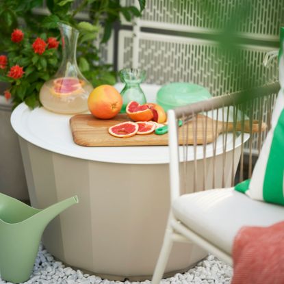 IKEA garden coffee table with oranges and a chopping board on top