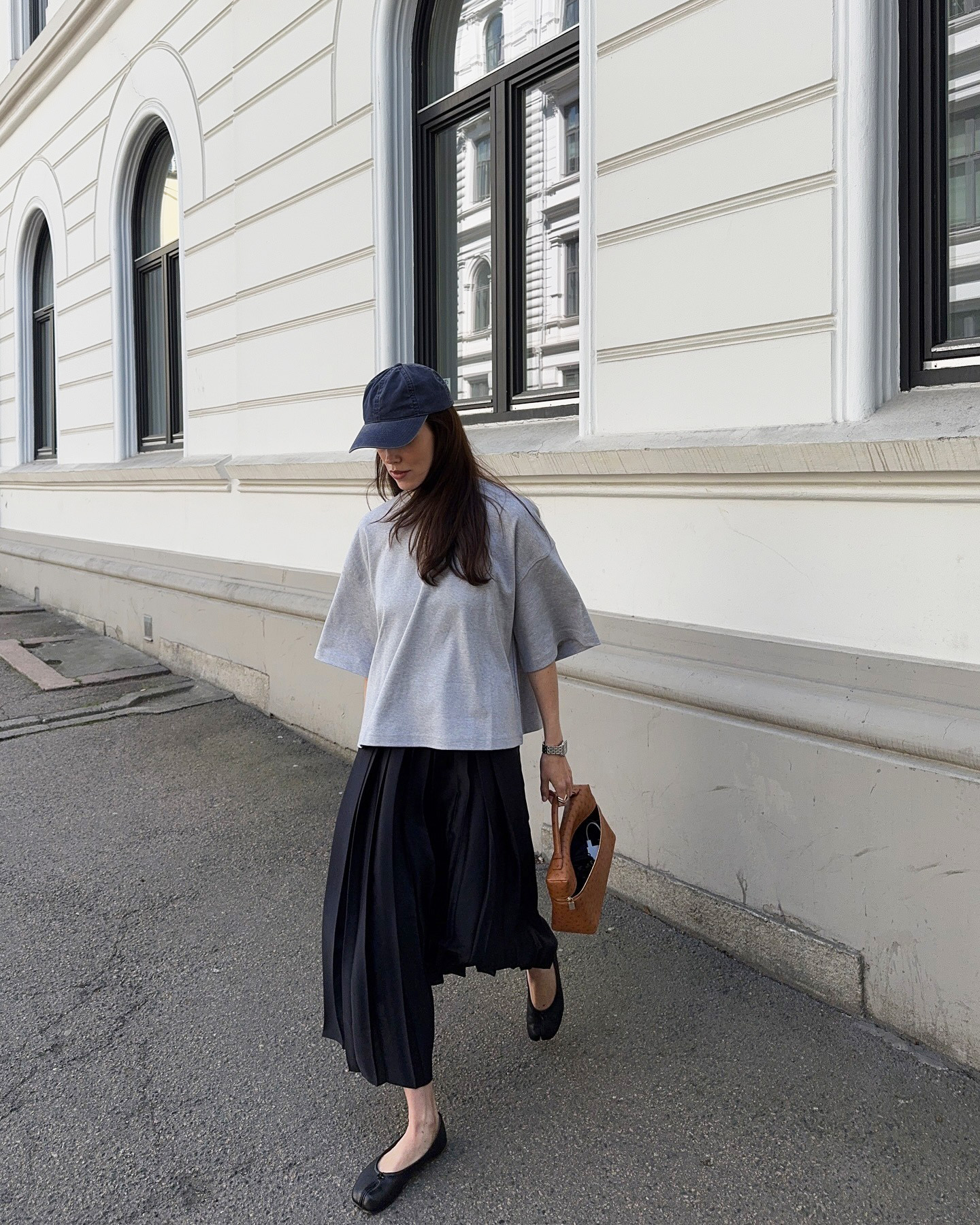 Influencer wearing a T-shirt, midi skirt, and ballet flats