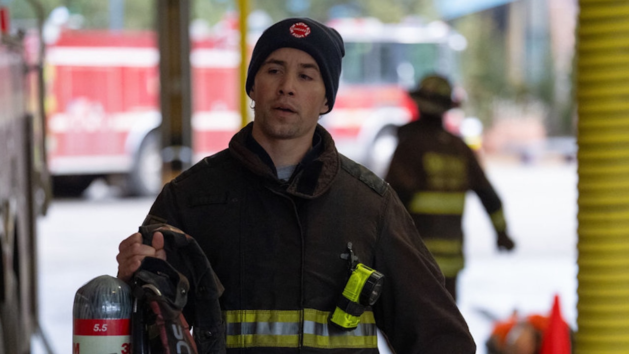 Vasquez carrying equipment to Truck 81 in Chicago Fire Season 14x15