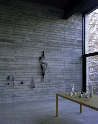 Models of Sosnowska’s installations are on display on the table and hang on the Atelier’s exposed concrete walls