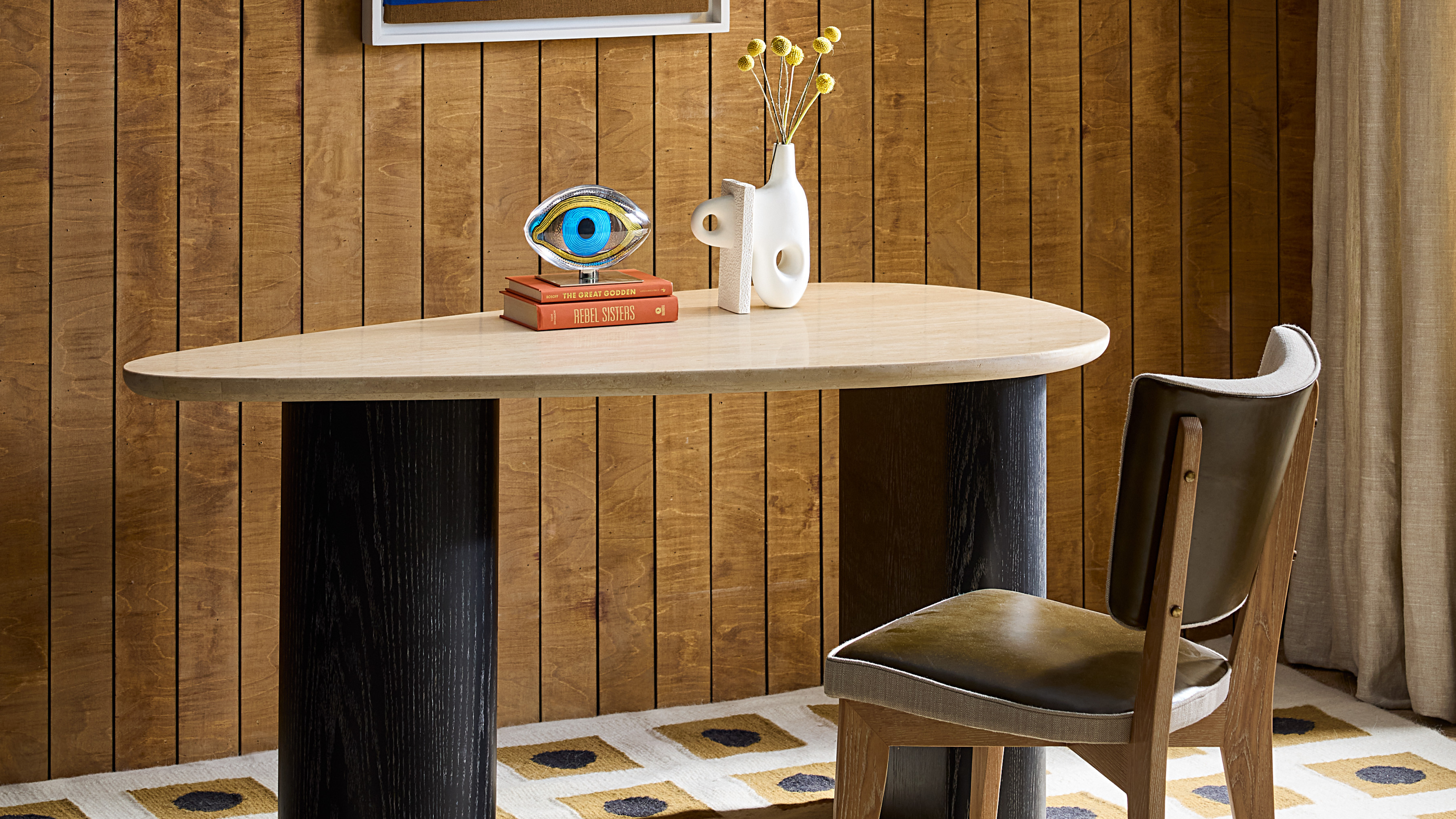 Wooden paneled home office with aysmmetrical double pedestal table 