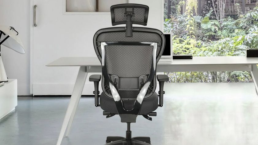 The Oak Hollow Aloria office chair seen from behind pushed into a desk
