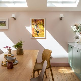 Kitchen dining area under sloped ceiling with rooflights