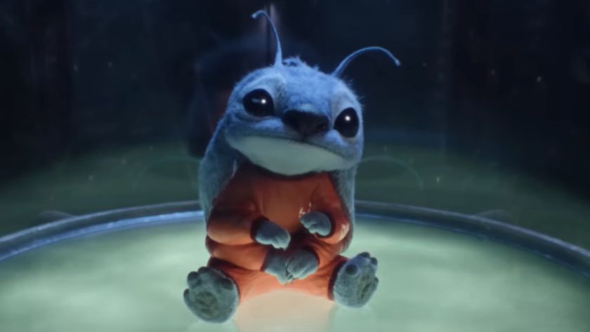 Stitch sits in his containment capsule with a curious look on his face in the live-action Lilo &amp; Stitch remake.