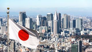 Panoramic view of Tokyo and Japanese flag, Japan.