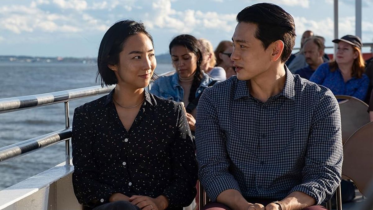 Two people sit on a ferry