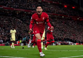 Takumi Minamino celebrates after scoring for Liverpool against Arsenal, 2021