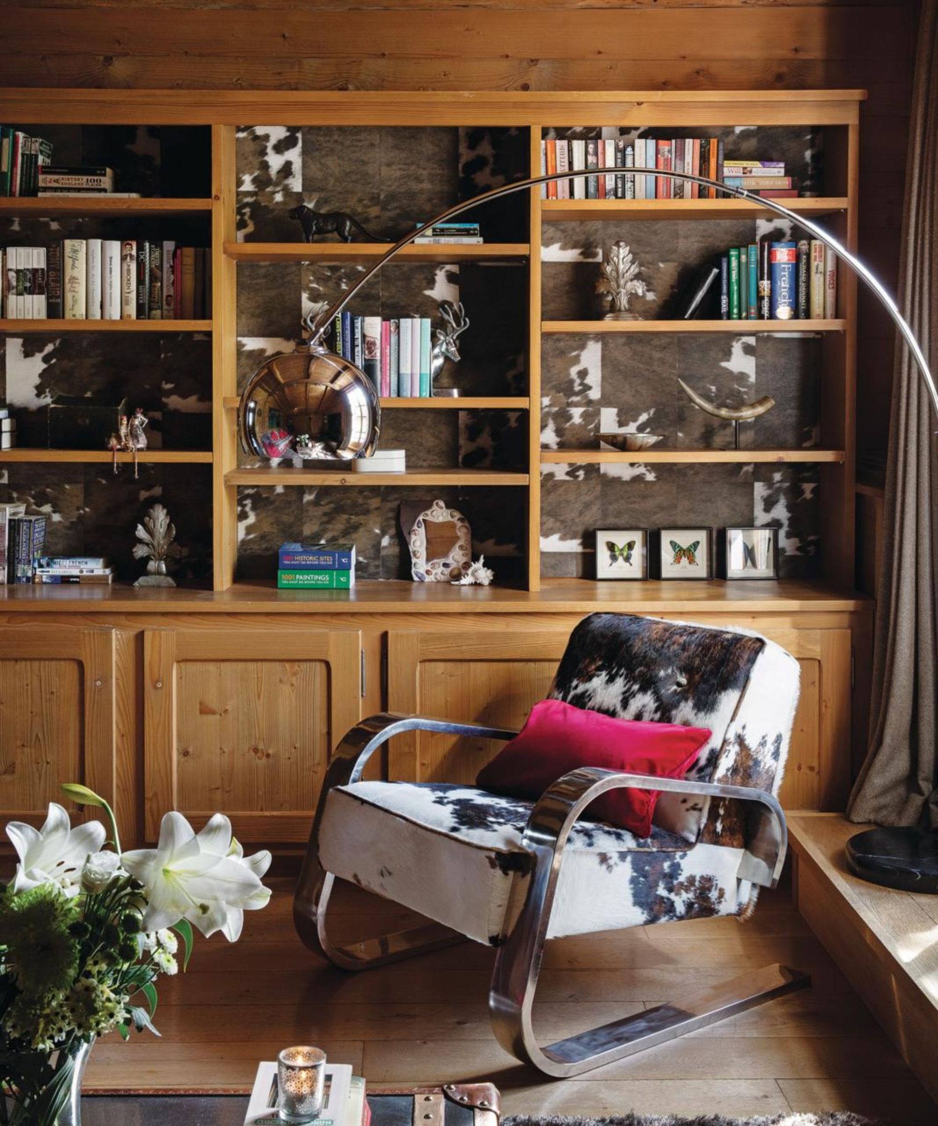 cabin with built in shelving and cow print chair