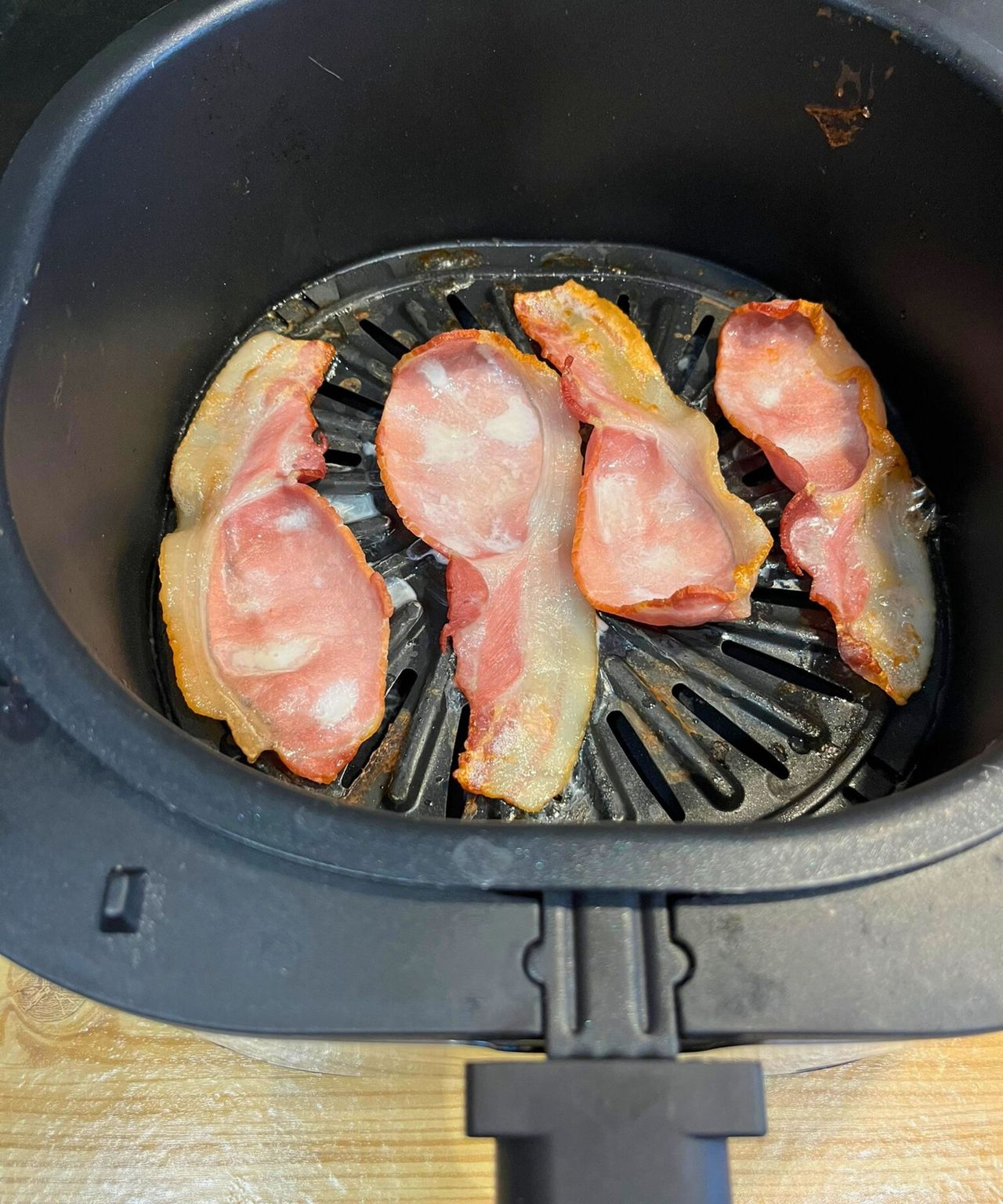 The crispy layer of bacon that cooked underneath the air fryer rack