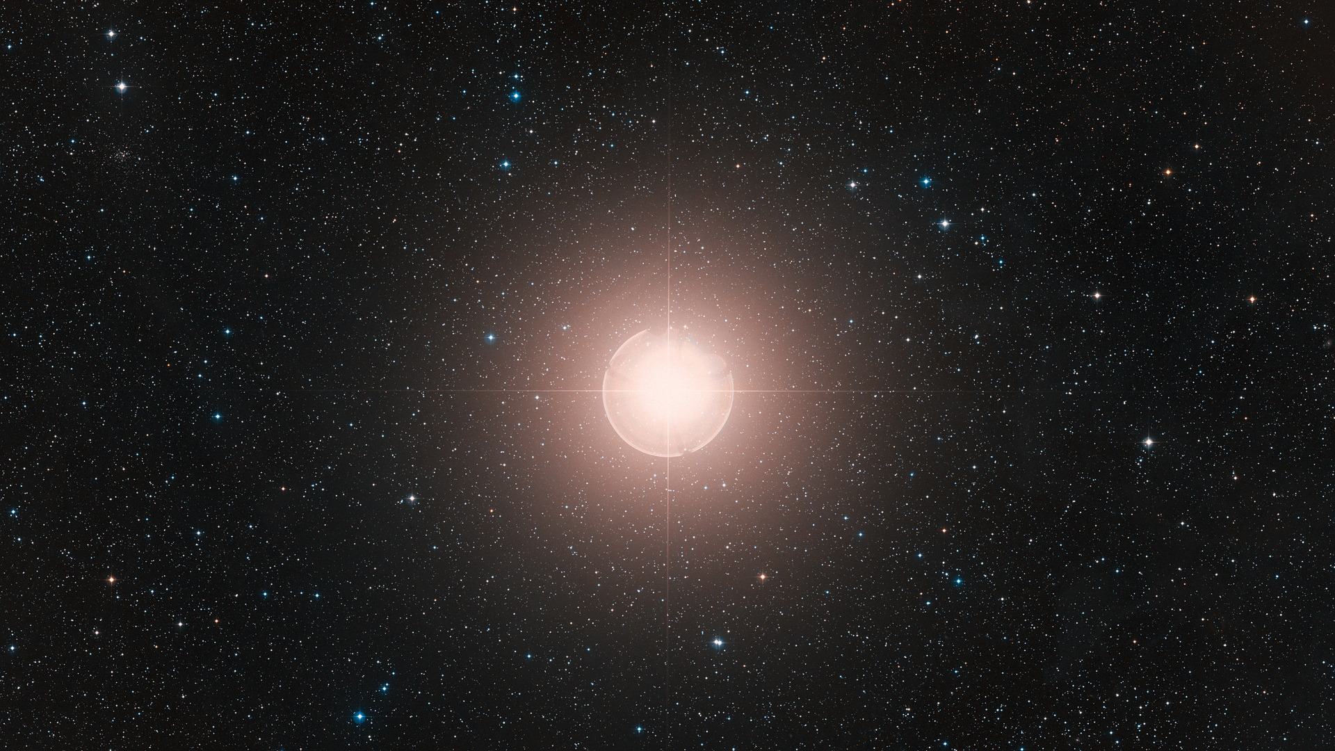 This image of Betelgeuse is a color composite made from exposures from the Digitized Sky Survey 2 (DSS2). A bright ball of light glows in the middle of deep space