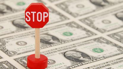 picture of a small stop sign on money