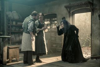 the evil witch comes into the baker and his wife's home in a still from Into the Woods