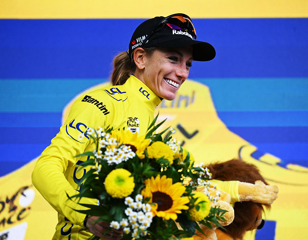 Pauline Ferrand-Prévot on the podium wearing the yellow jersey at the Tour de France Femmes 2025