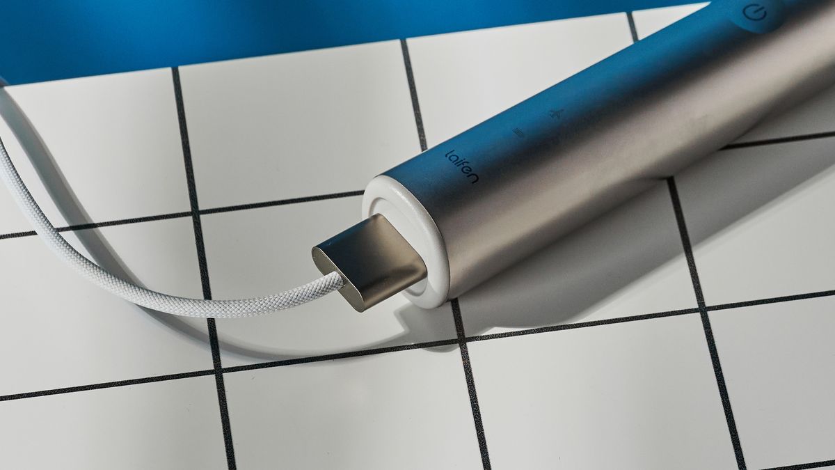 the laifen wave electric toothbrush with a white gum cleaning brush head
