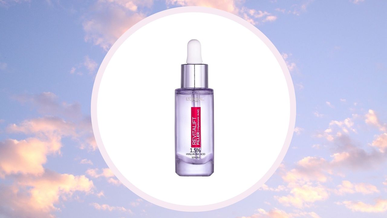 the L&#039;Oreal Paris Revitalift Filler serum on a white circle against a purple/blue sky with white clouds