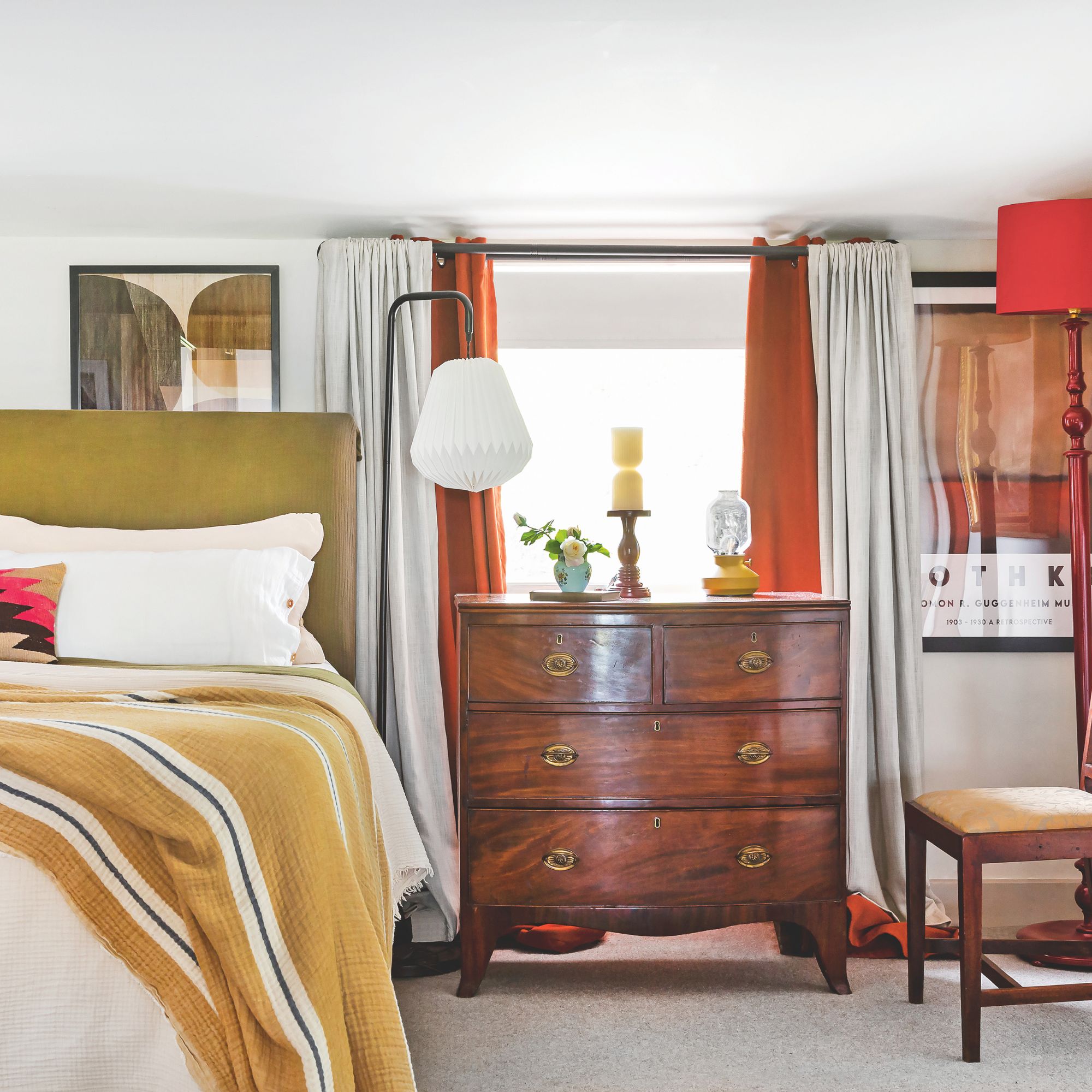 Bedroom with attractive colors and wooden dresser, green headboard