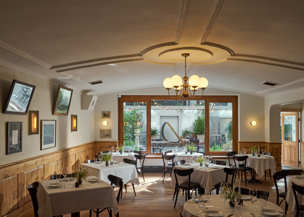 The interiors of a trattoria-inspired Italian restaurant in NYC bridge the old and the new.