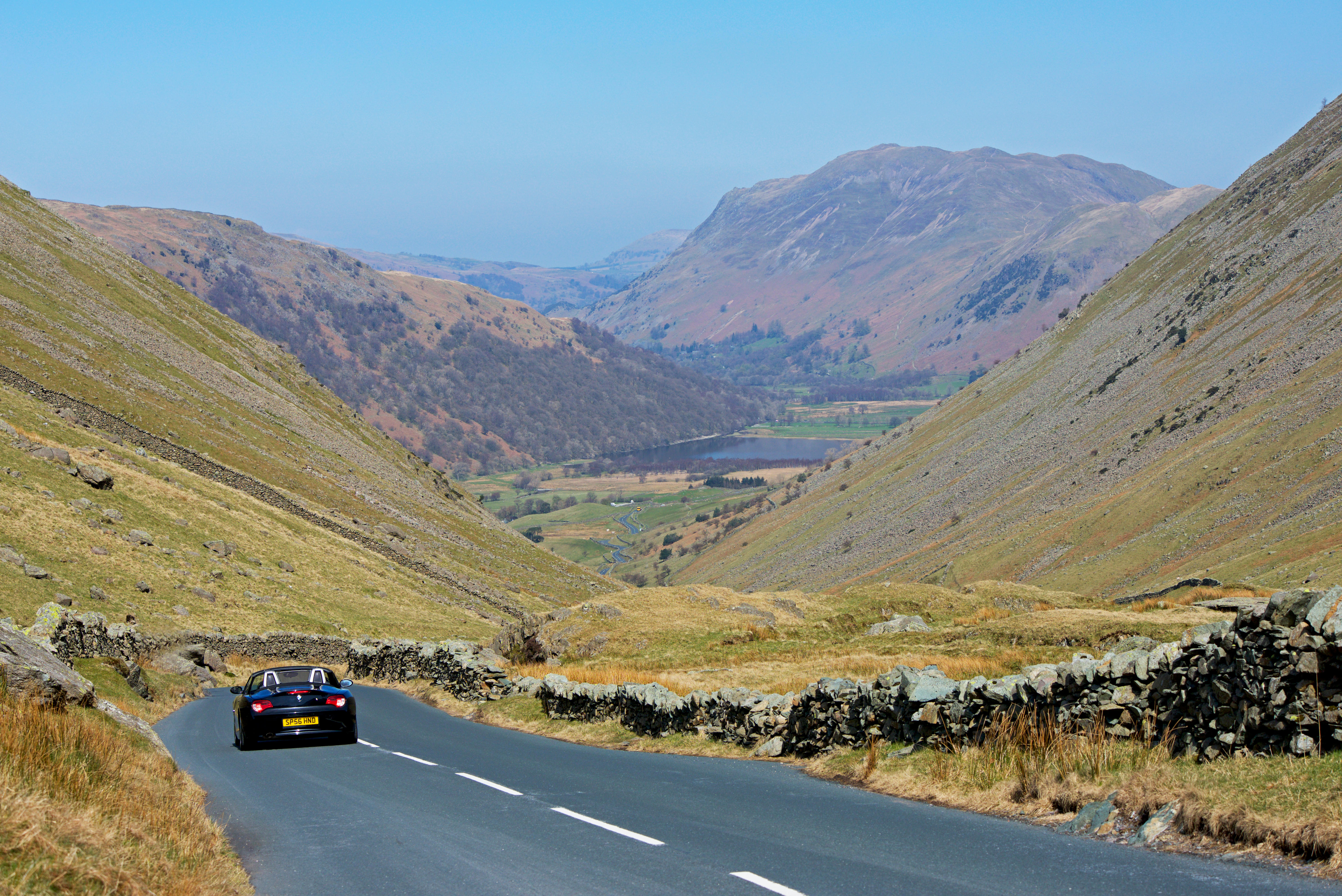 Sports car descending Kirkstone Pass, Lake District National Park, Cumbria, England UK