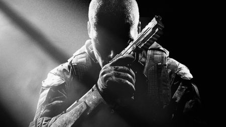Key art for Call of Duty Black Ops 2 showing a character sitting in darkness with a handgun, from Edge 353