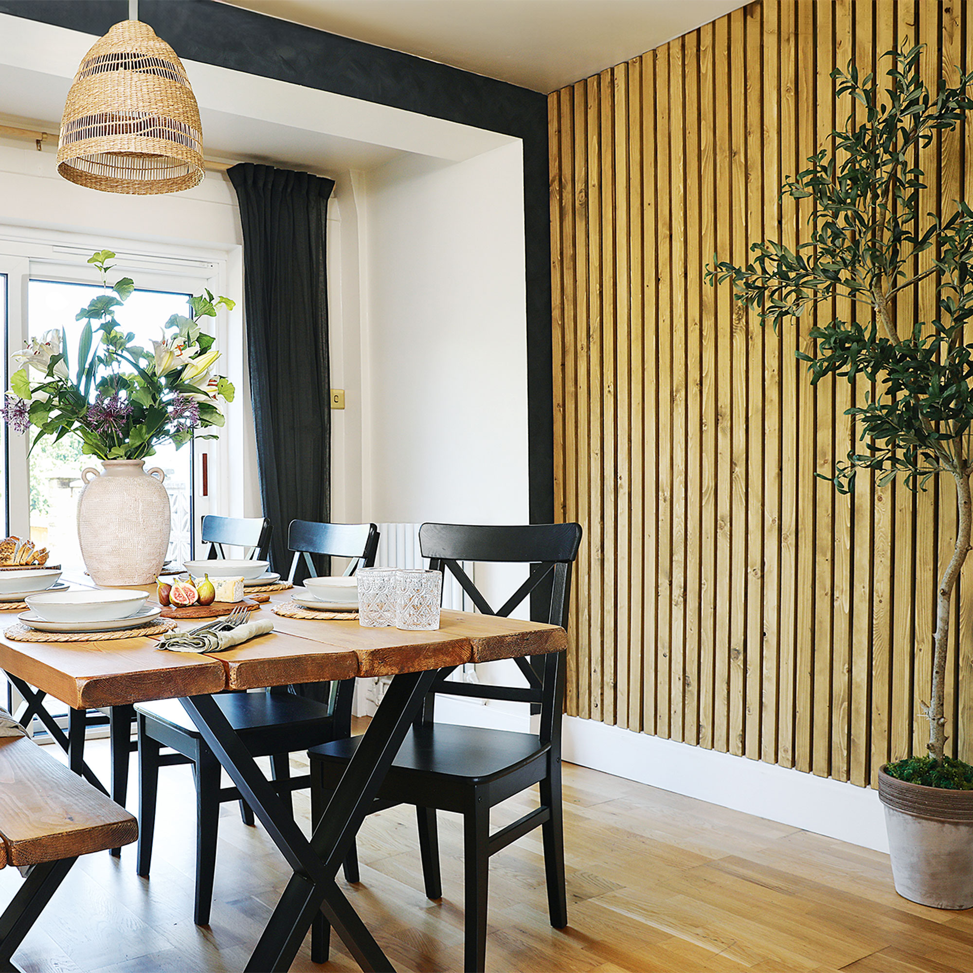 dining room with table and slatted wall