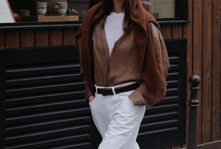 woman in white jeans and brown shirt