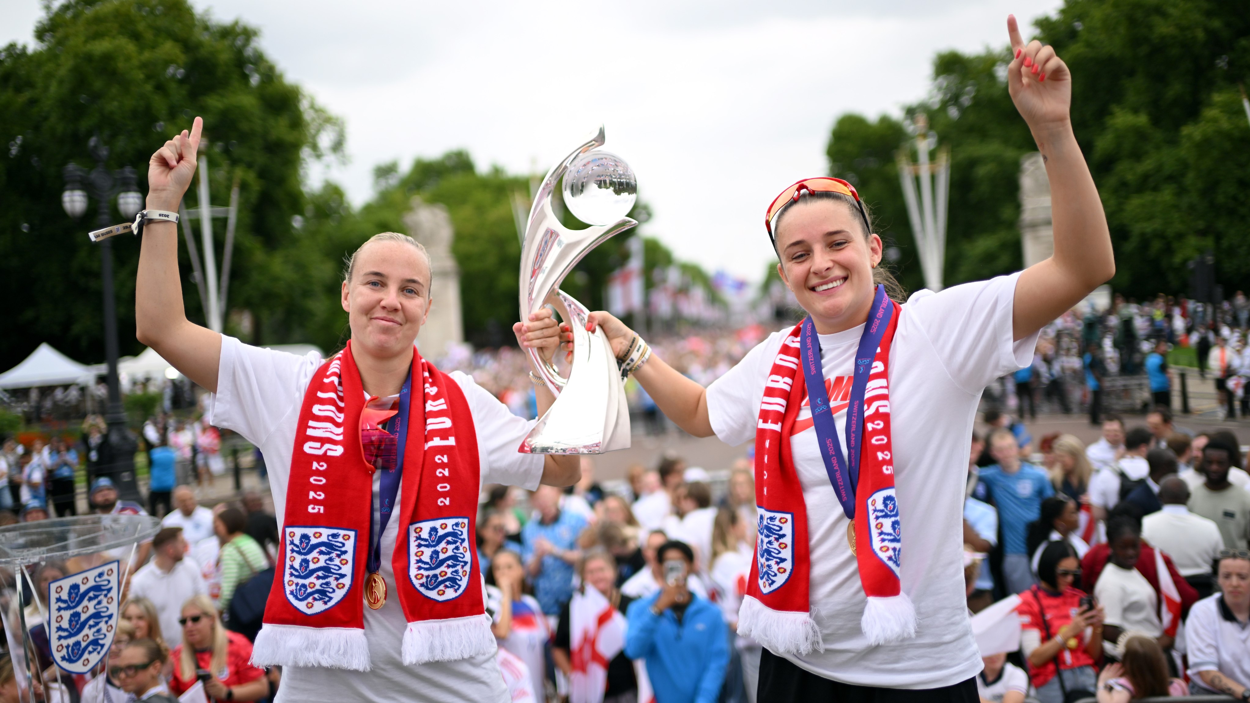 Beth Mead and Ella Toone of England pose for a photo on stage with the UEFA Women's EURO trophy during the England Women's team victory parade and celebration on July 29, 2025