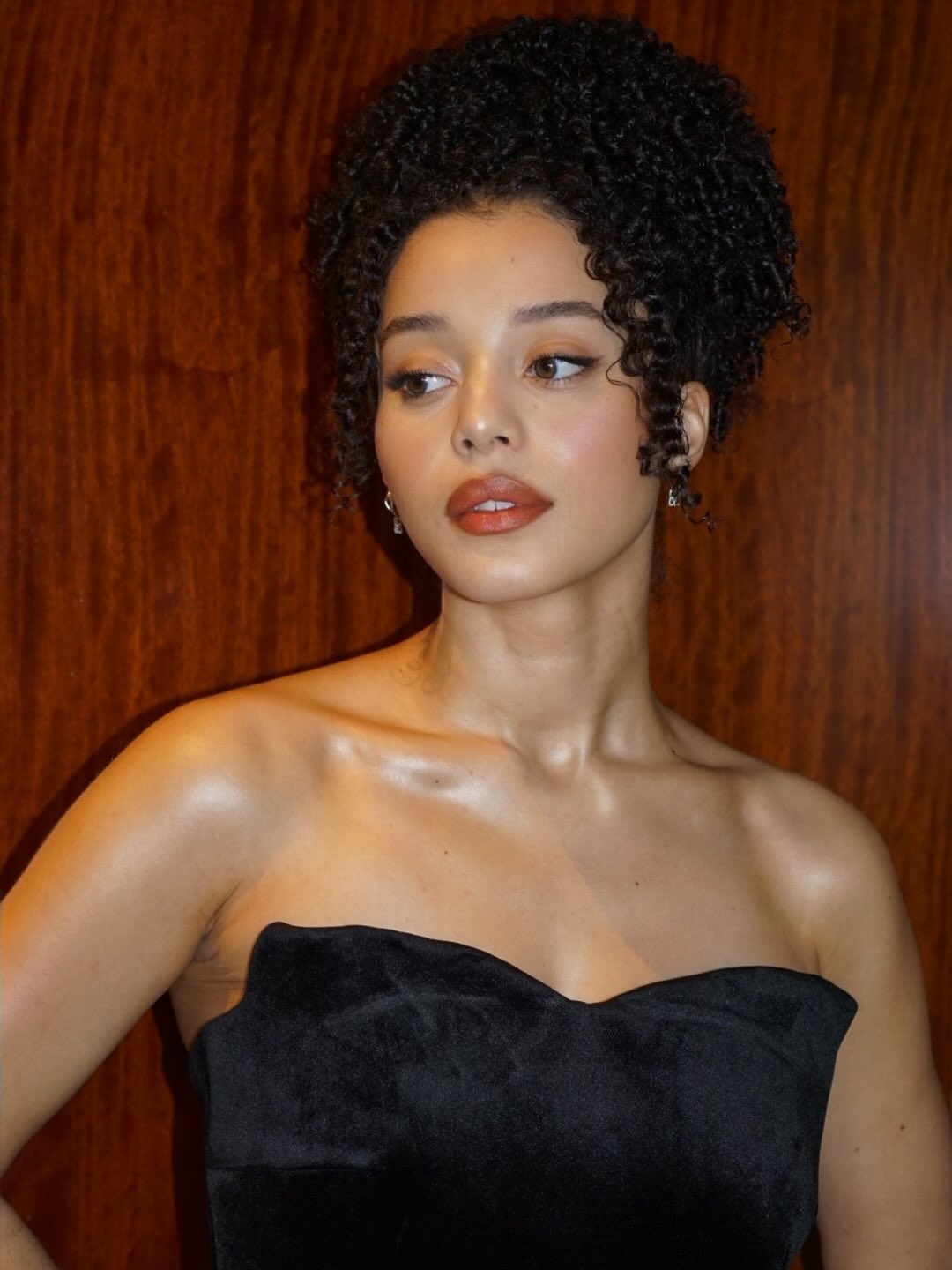 Chase Infiniti with curly hairstyle high pony