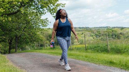 woman in sports kit walking outside