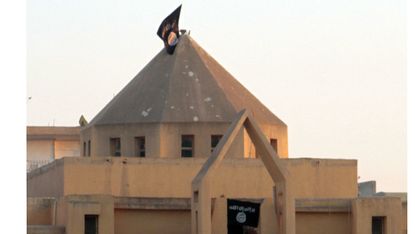 The flag of IS flutters on the 'dome' of a Syrian Christian Church