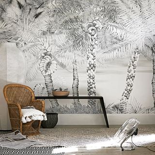 palm tree prints on wall and rattan chair.