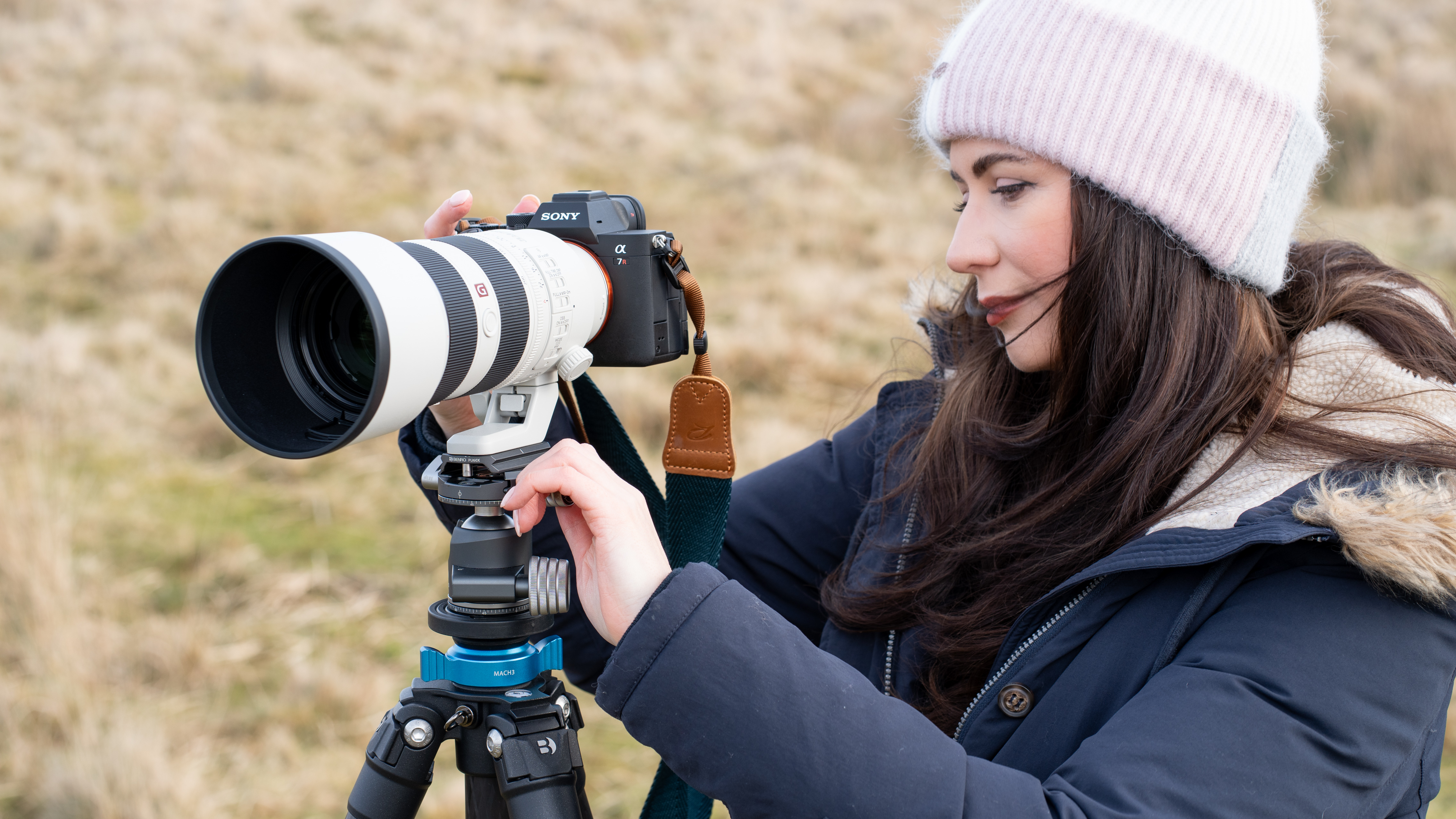 woman setting up a camera on a tripod