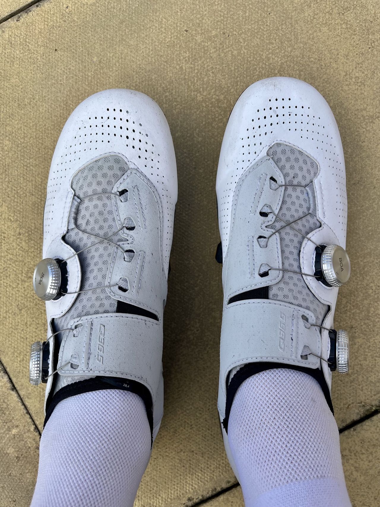 A pair of white q36.5 Unique Pro shoes