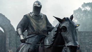 Dunk (Peter Claffey) wearing his suit of armor, visor down, on horseback in a scene from "A Knight of the Seven Kingdoms" episode 5.