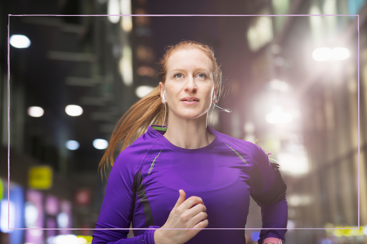 Close up of a woman going for a jog at nighttime 