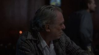 Charles Bukowski as bar patron looking off to the side in Barfly