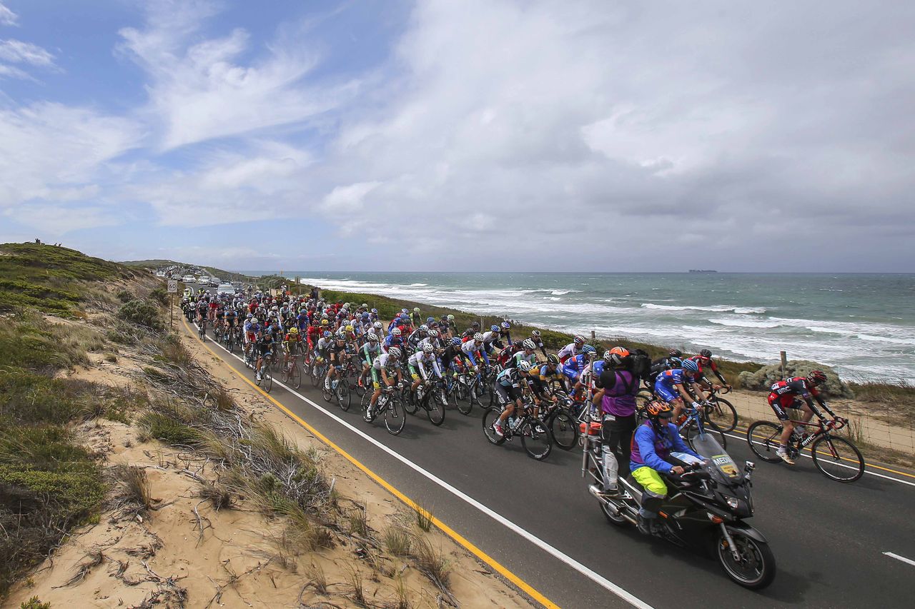 The peloton passing by the wild ocean